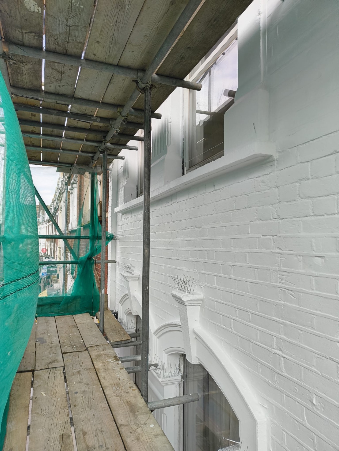 Scaffold lift in place against the freshly prepared elevation during the works