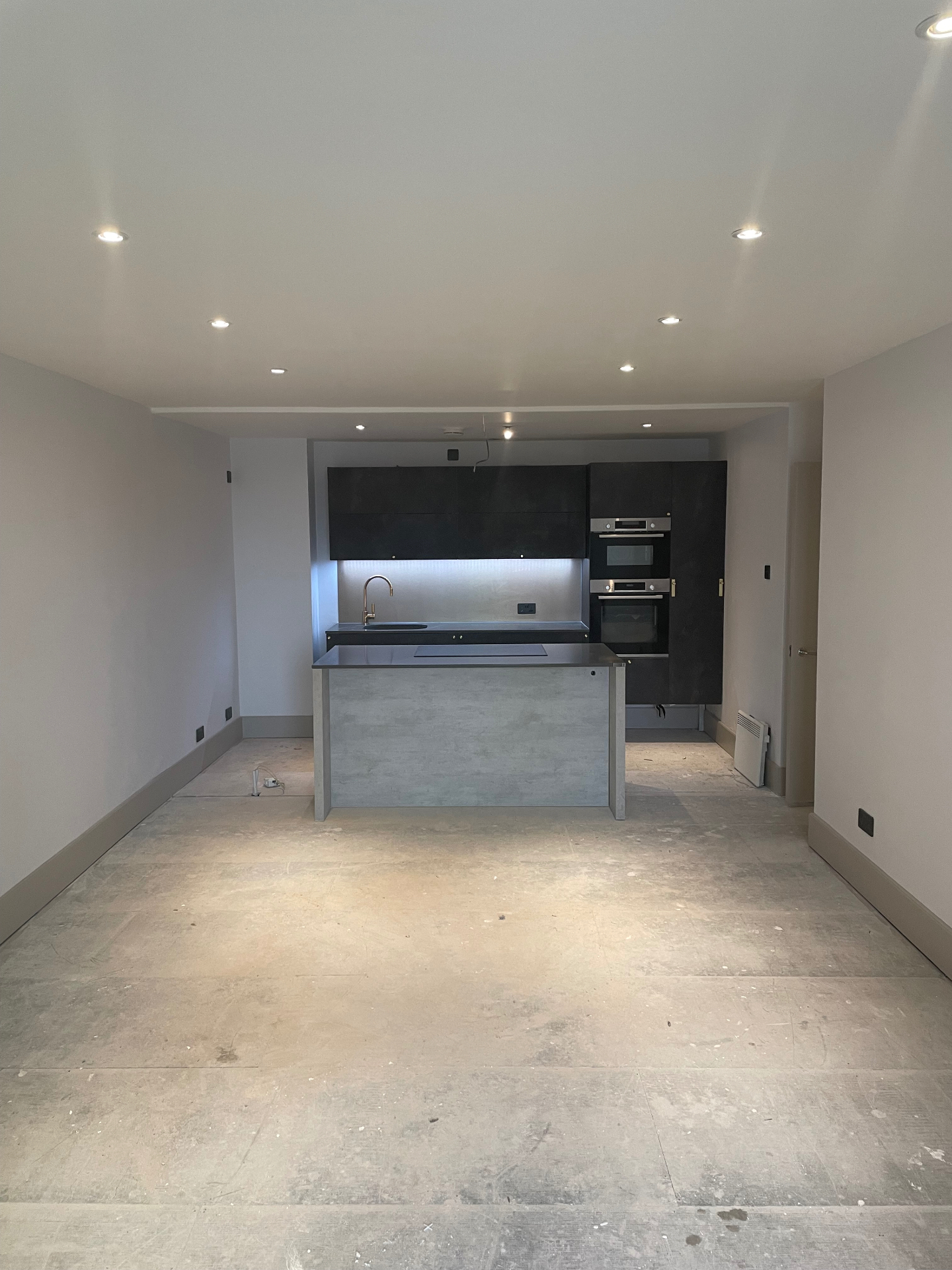 Wide view of the refurbished open-plan kitchen and living area