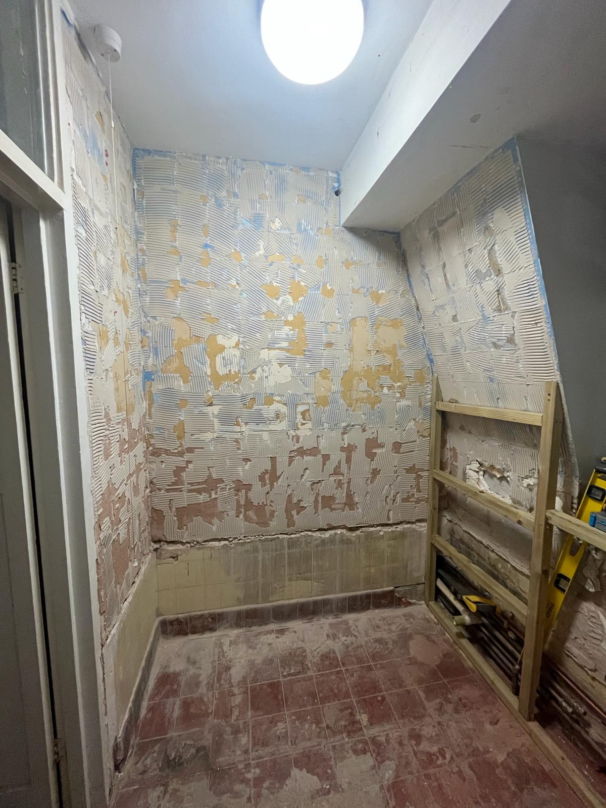 Walls stripped back to substrate with adhesive removed