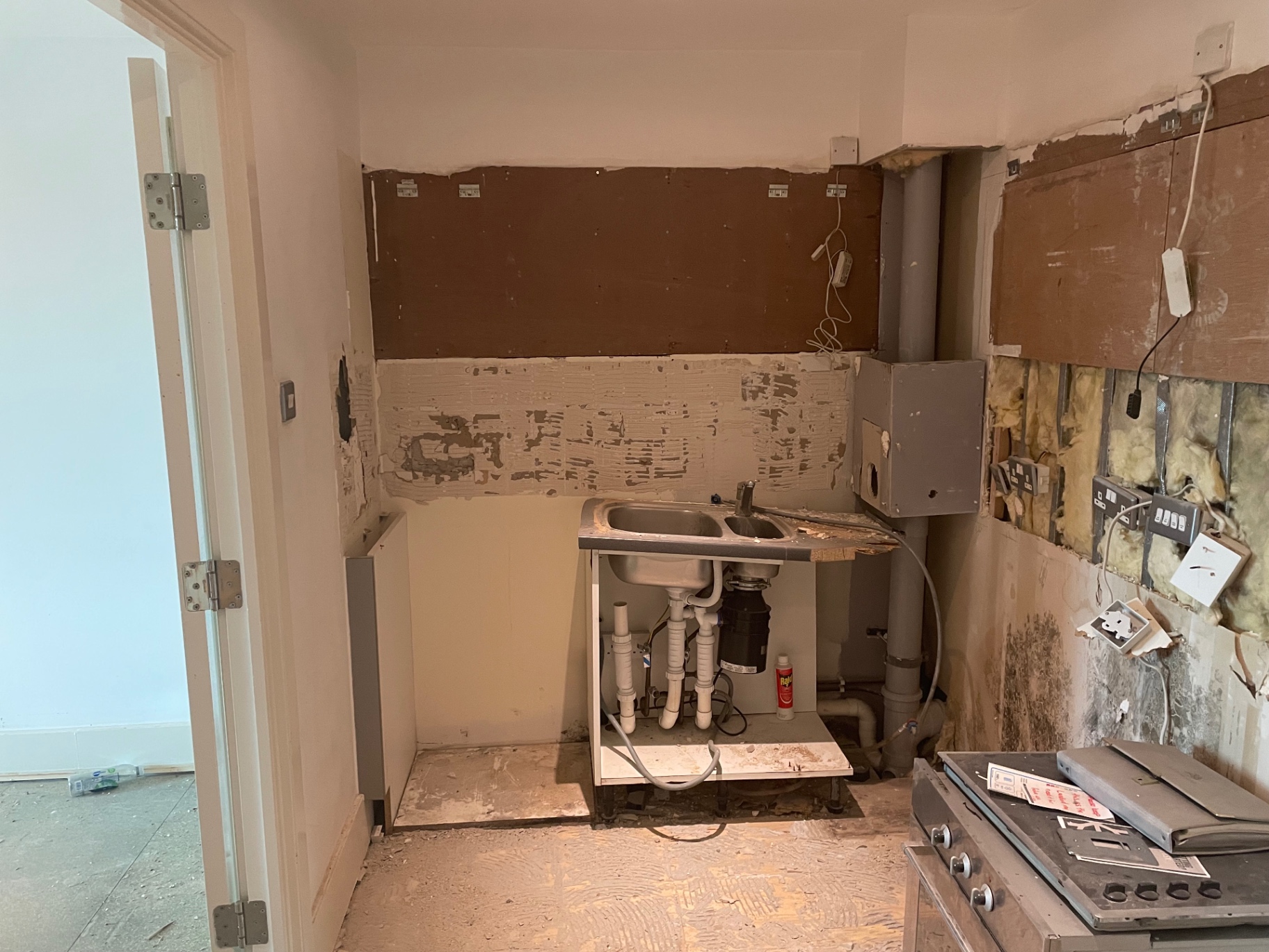 Former kitchen sink and units during strip-out at St George’s Wharf