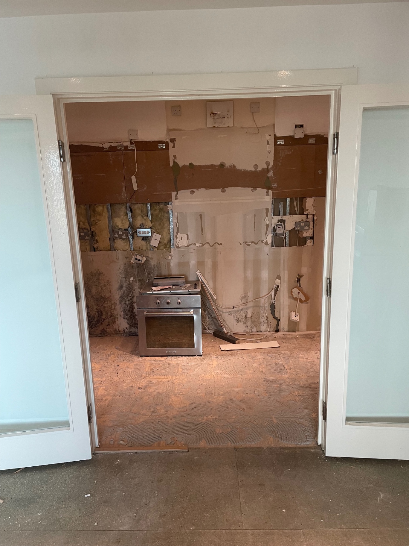 Existing kitchen wall exposed during the strip-out