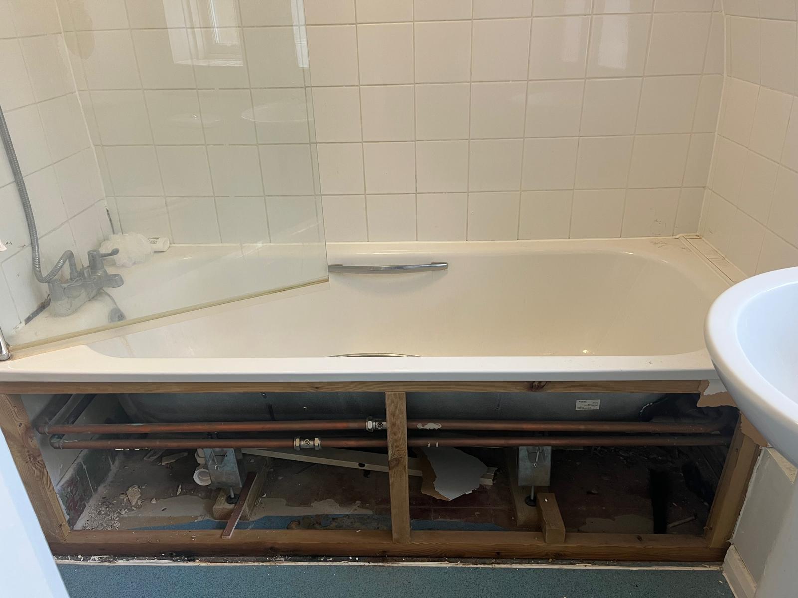 Bath panel removed showing the original copper pipework